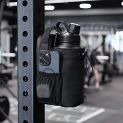 Black water bottle holder with phone pocket attached to a gym rack